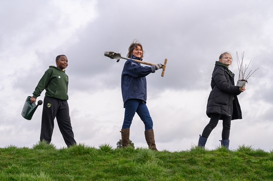 Water Orton Primary School pupils and a representative from HS2 getting reading to plant donated oak saplings, March 2022