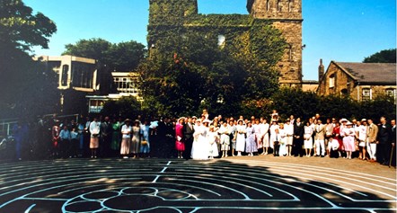 Large wedding part pictured in front of a former castle keep