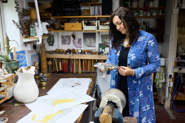 Reflections in Silver: Artist Miriam Handid has been crafting her Phoenix Jug piece in her Suffolk workshop after being inspired by the birds of Temple Newsam, in particular an 18th century side table designed by John Vardy and the Chinese Drawing Room wallpaper featuring birds cut from John James Audubon’s book The Birds of America. Credit Leeds Museums and Galleries Nick Singleton.