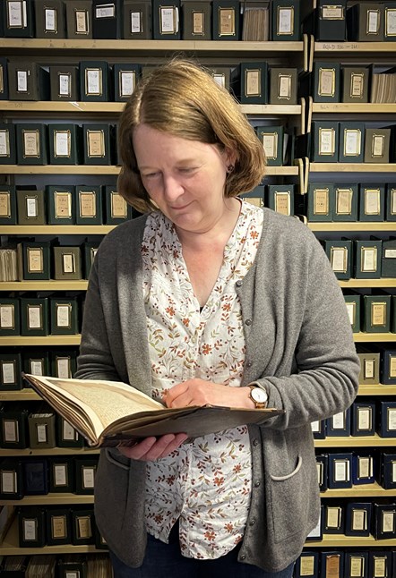 Manuscripts Curator Dr Ulrike Hogg with the Chronicle of Fortingall manuscript, circa 1554-1579
