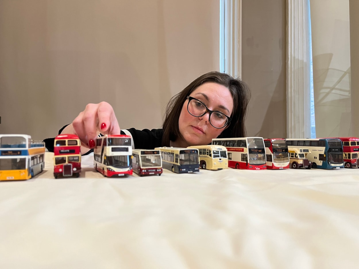 Bus collection: Assistant community curator Sapphia Cunningham-Tate alongside the new display at Leeds City Museum which gives visitors a chance to see a selection of the vast array of replicas created by physicist Dr Gordon Brooke.
The meticulously detailed models each relate to a specific real-life equivalent, complete with service number and with every painstaking detail reproduced using card, packaging and acetate for the windows.