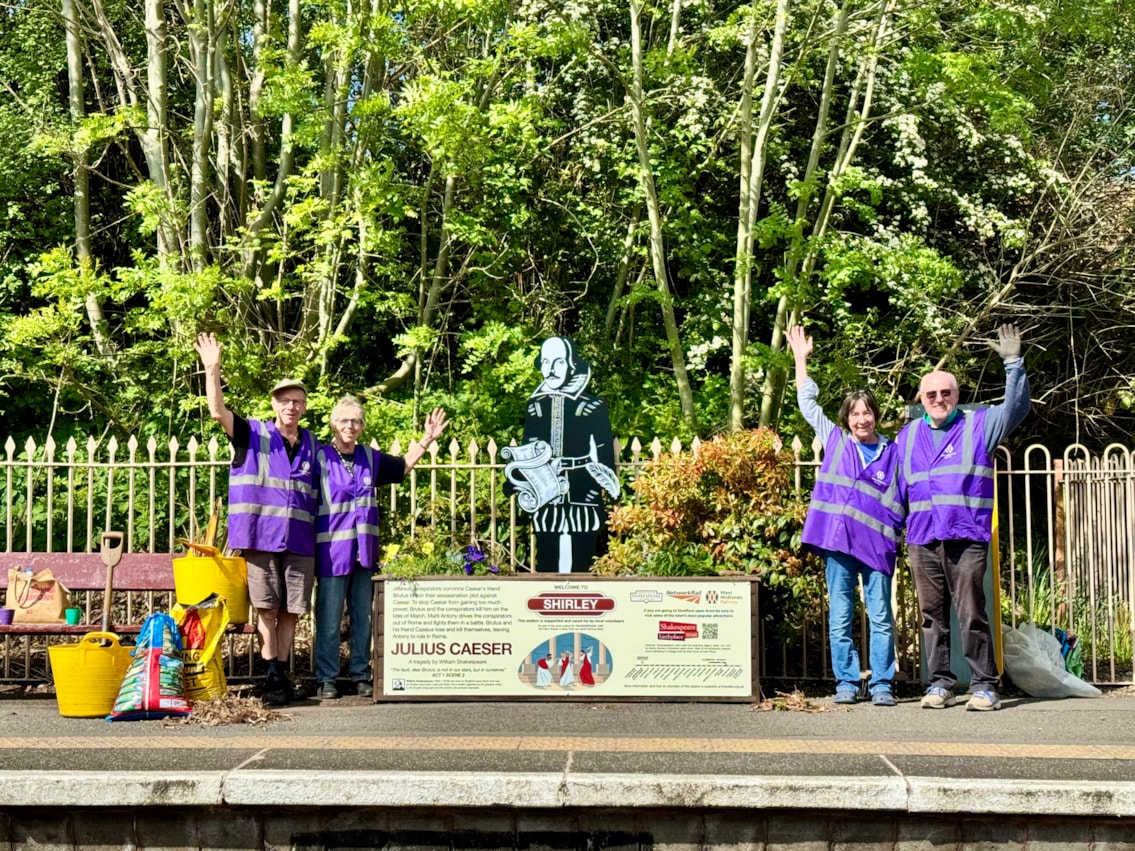 Volunteers installing a Shakespeare statue and planter at Shirley