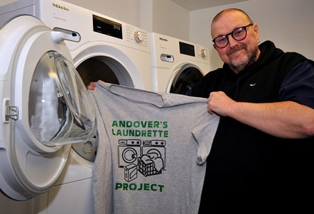 Local resident, Robert, and the T shirt he designed, at the Andover Estate community launderette
Keith Emmitt Photographer