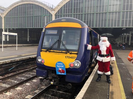 This image shows Father Christmas with the festive train
