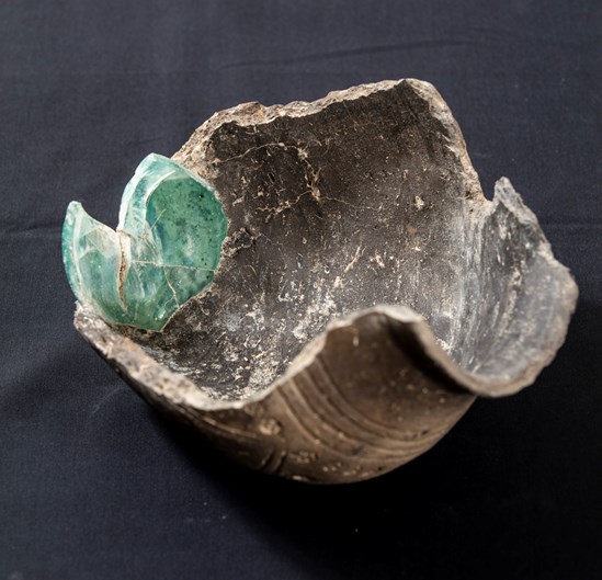 A unique 6th century ceramic window urn with reused Roman glass fired into the bottom uncovered during HS2 archaeological excavations in Wendover: A unique 6th century window urn with the bottom of a reused Roman glass bottle fired into the ceramic. 

Tags: Anglo Saxon, Archaeology, Grave goods, History, Heritage, Wendover, Buckinghamshire