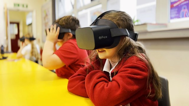 Virtual reality headsets teach children about railway safety: School girl wearing VR headset