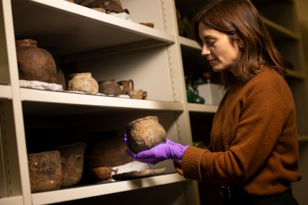 Curator Dr Sarah Laurenson with objects from the collection of National Museums Scotland to be studied as part of new Gaelic language project, Tha Sgeul Ri Innse [credit Duncan McGlynn]