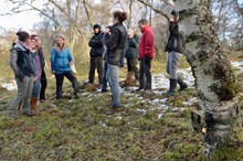 Scottish Wildcat Action project officers and volunteers: Wildcat Action projects officers and volunteers, Cairngorms National Park, with camera trap fitted to tree in foreground. ©Lorne Gill/NatureScot