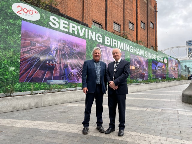 Railway scenes by famous artist proudly on display at Birmingham New Street: John Austin and Fraser Pithie in front of artwork
