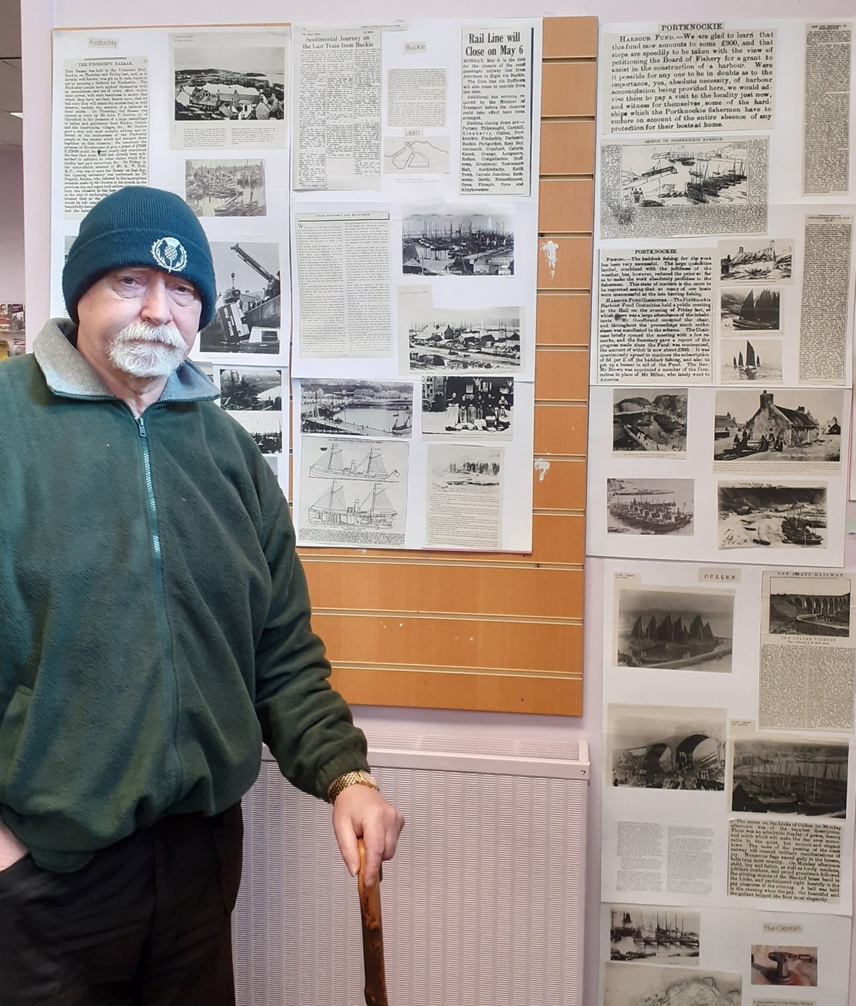 Tony Slater stands next to one of his exhibitions at the heritage centre.