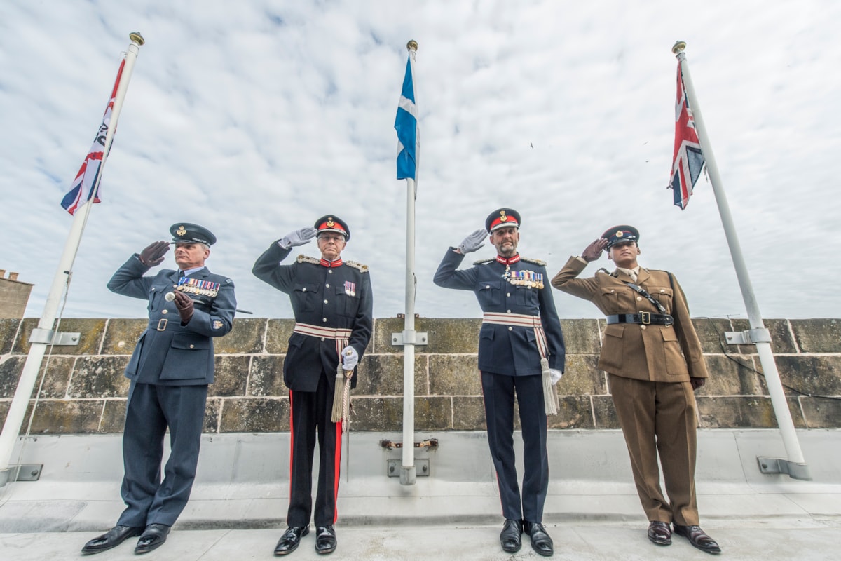 L-R: RAF Lossiemouth Station Warrant Officer Joe Mulholland; Lord Lieutenant of Banffshire Andrew Simpson; Lord Lieutenant of Moray Alistair Monkman; Lieutenant Subin Gurung, 39 Engineer Regiment saluting the VE Day 80 flags on top of Moray Council HQ.

Image: Jason Hedges/DC Thomson