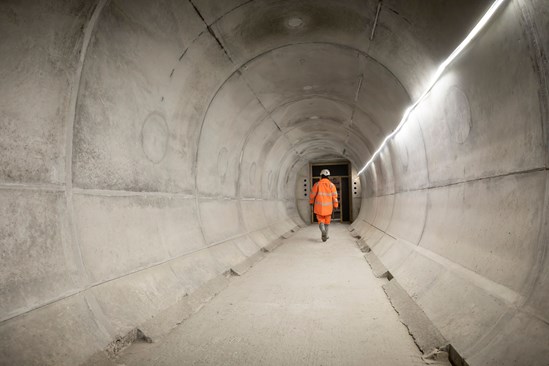 Contractor walking through a Chiltern tunnel crosspassage Nov 2023