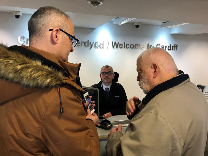 Jonathan Colligan from Interpreter Now shows Jonathan Bosman, of the deaf community how to use the app at Cardiff Central Booking office