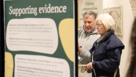 Cllr Mike Evemy speaks to a resident at a Local Plan consultation event in Cirencester in December 2025