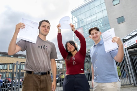 Capital City College Group students, from left, Pablo, Keightly and Dragos, celebrate their results outside the Angel campus
