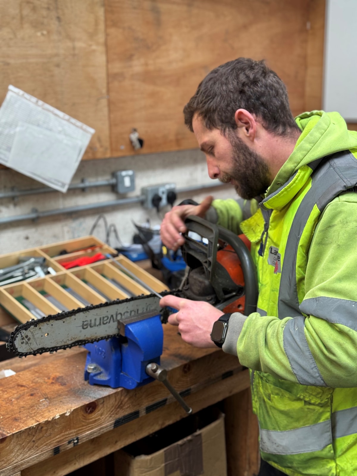 Arborists in LCC's highways team prepare for the storm by  sharpening a chainsaw.