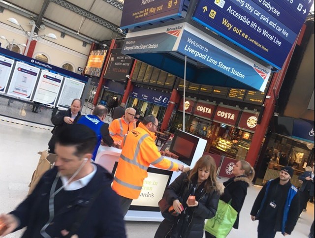 Network Rail staff handing out thank you cakes to passengers at Liverpool Lime Street