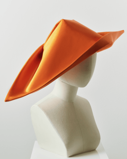 Image of a striking orange cornette on a mannequin.