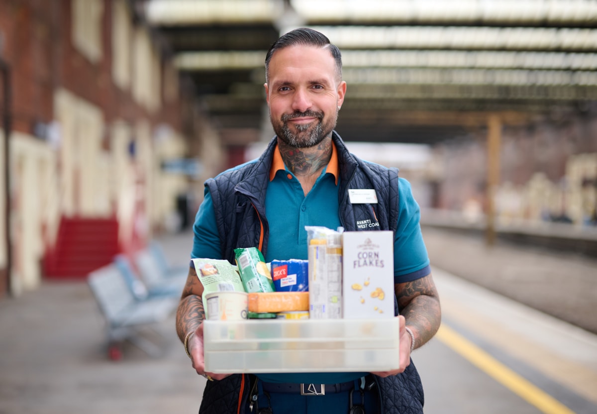 Zeb Nash, who volunteers as an Avanti West Coast Community Champion, with a collection box for donations made to Stoke-on-Trent Foodbank