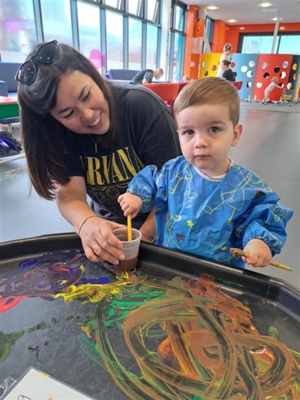 George, who is nearly two, gets stuck into painting at the Skelmersdale Family Hub and the Zone