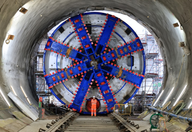 Construction worker in front of the TBM Anne cutterhead at Victoria Road