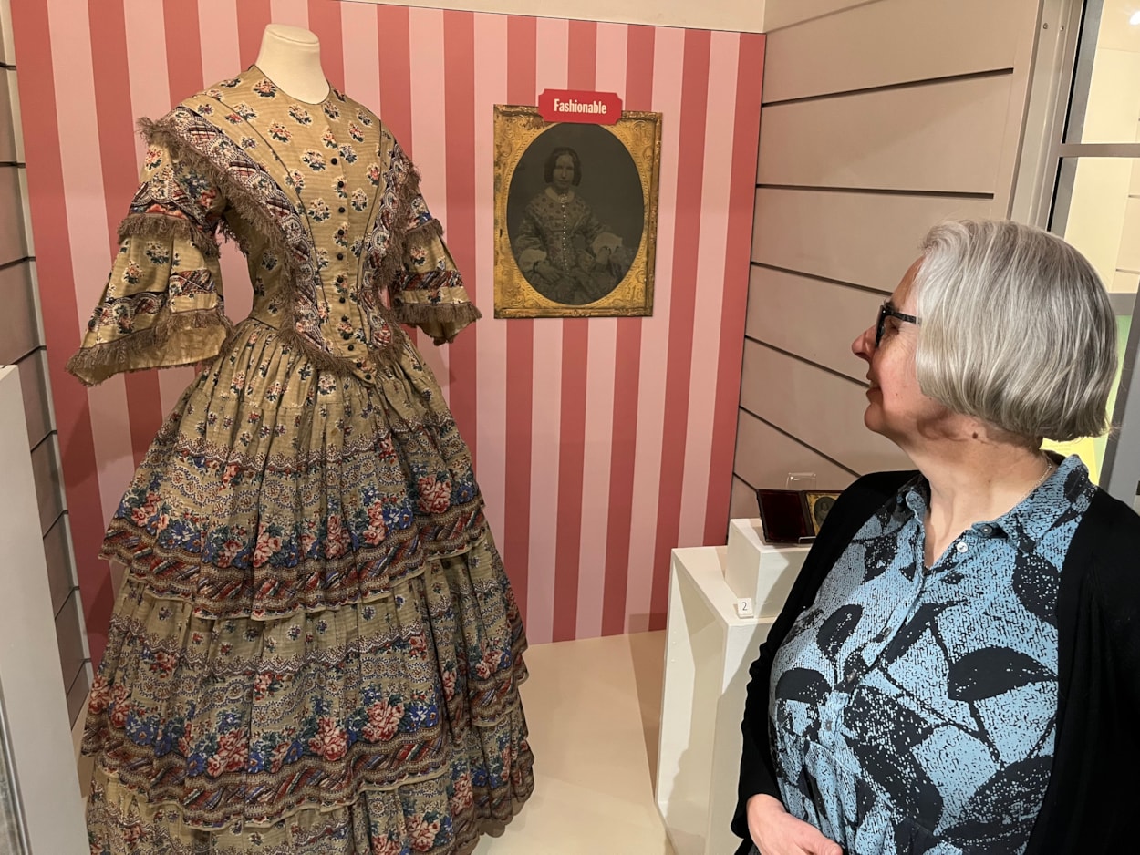 In the Picture: Curator Kitty Ross admires a beautiful printed cotton dress made in around 1855.
The dress is on display as part of In the Picture at Abbey Housee Museum.