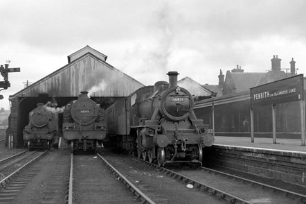 Cumbrian Railways Association A Busy Penrith in 1951: Please credit Cumbrian Railways Association. 

A busy day at Penrith circa 1951 with a Darlington via Stainmore train (right) and a service to Keswick (left). Locomotive 42313 (centre) is awaiting its next working.