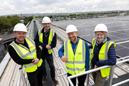 A photo showing a group of four on the roof of the Islington Waste and Recycling Centre, showing the newly-installed solar panels