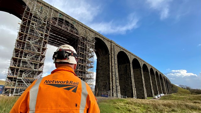 Iconic Ribblehead viaduct repaired for ‘Staycation Summer’: Ribblehead viaduct with Network Rail worker in the foreground