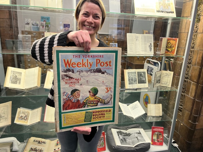 Library Christmas books: Library and digital assistant Anna Jones with a Christmas edition of the Yorkshire Weekly Post from 1933.