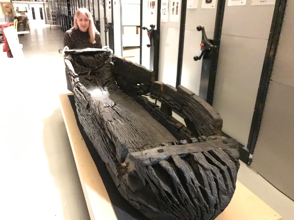 Giggleswick Tarn logboat: Kat Baxter, Leeds Museums and Galleries curator of archaeology with the centuries-old carved logboat, which dates from the 1300s. The  watercraft had lain beneath the soil for more than 500 years before being discovered by Joseph Taylor in 1863 while he was digging some drainage works near Giggleswick Tarn in North Yorkshire.