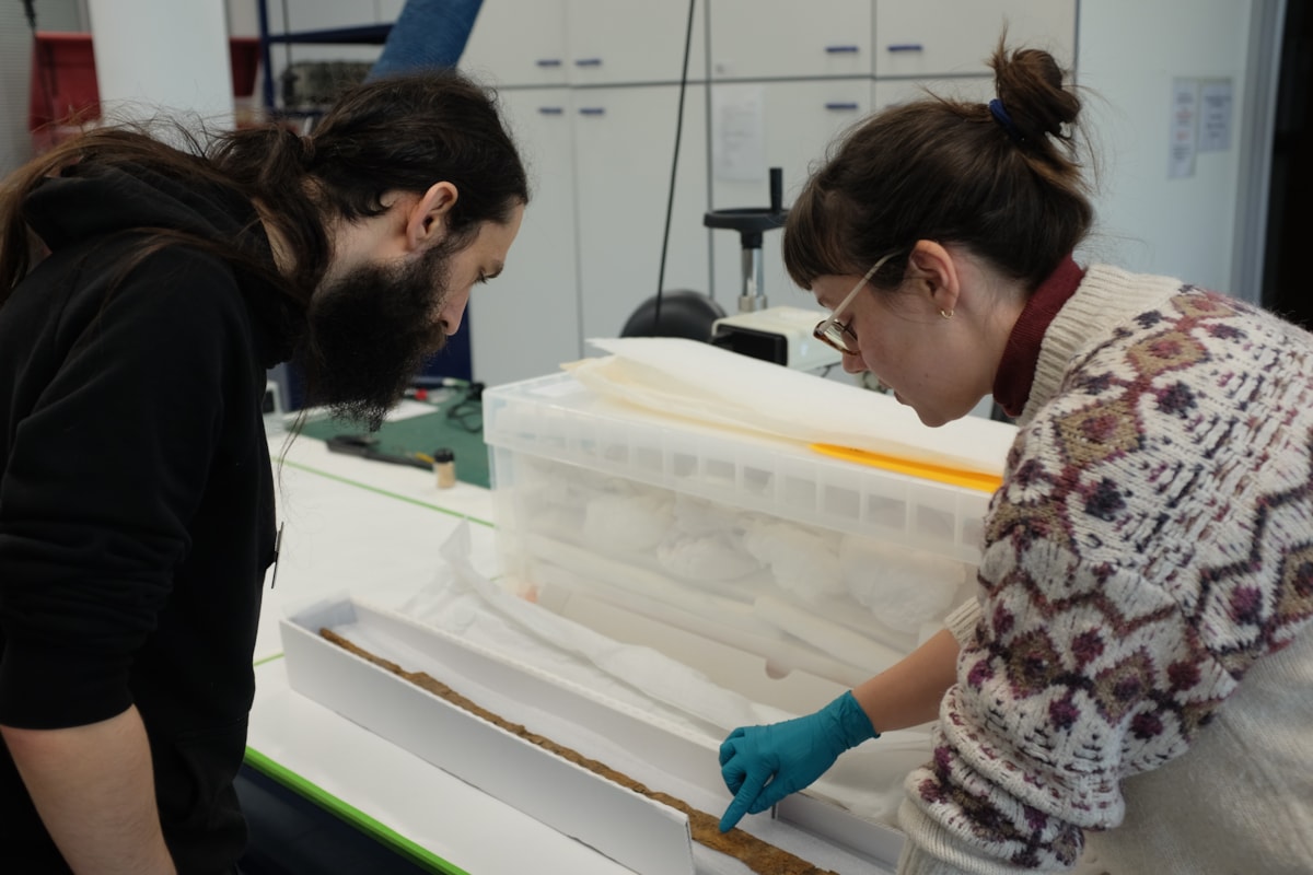 Conservator, Kayleigh Spring, showing Phillip Brant-Simmons from the Corinium Museum the sword post conservation. Copyright CMAS, Wiltshire Conservation