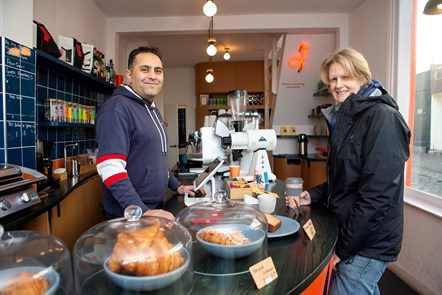 Cllr Champion buys a warm drink from Ashkan Pedram, the cafe manager for Trampoline Cafe on Camden Passage