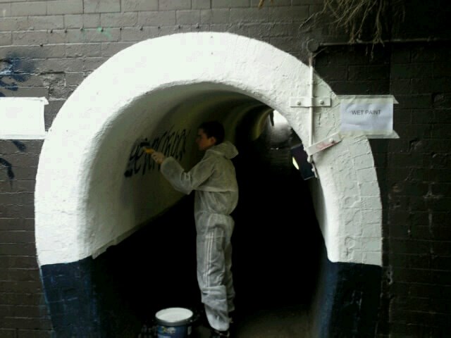 Young offender removing graffiti at Grantham Station: Young offender removing graffiti at Grantham Station