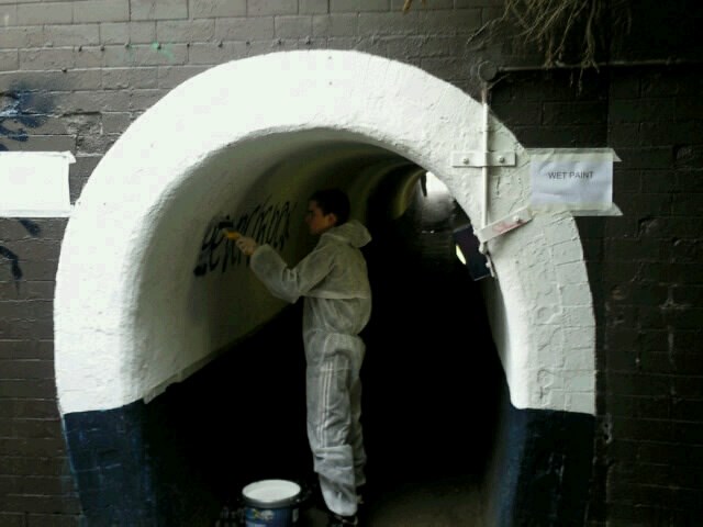 REHABILITATING GRANTHAM’S UNRULY YOUNGSTERS AND IMPROVING FACILITIES FOR PASSENGERS: Young offender removing graffiti at Grantham Station