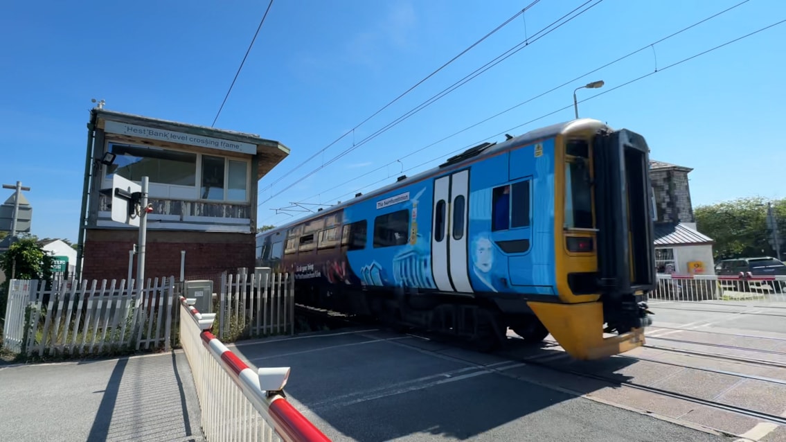 Northern train passing by Hest Bank signal box July 2026