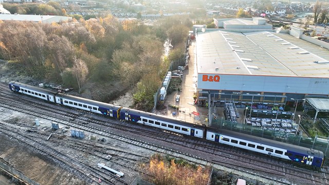 Northern train passing over repaired Petteril Bridge junction with B&Q in background