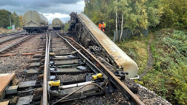 Complex recovery continuing one week on from Carlisle train derailment: Wide shot of scene of Carlisle freight train derailment