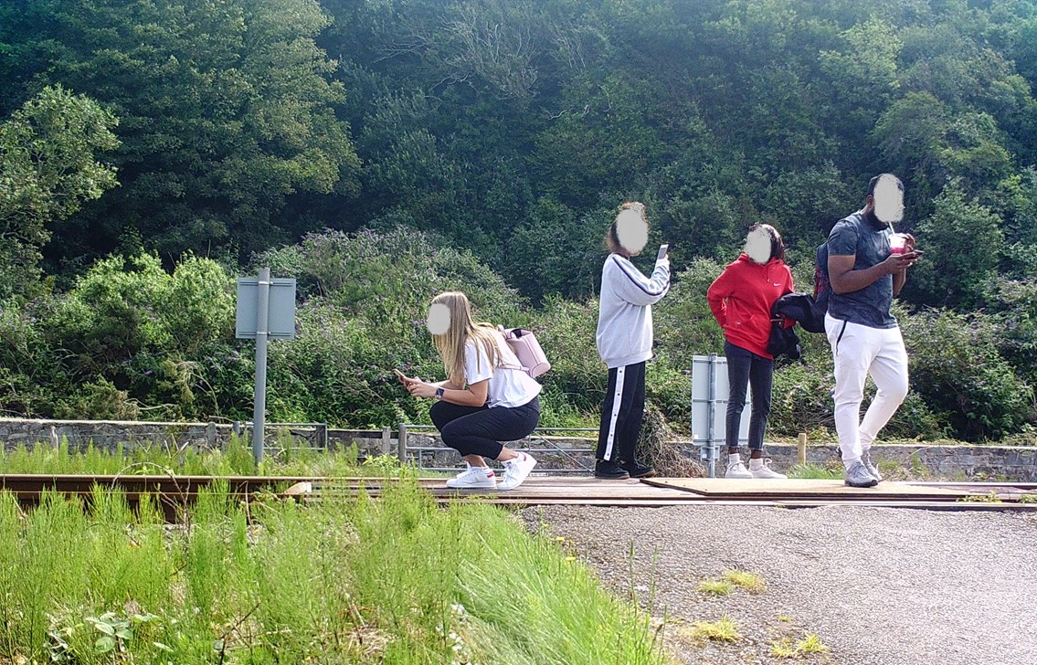 Public urged to stop taking risks after worrying surge in trespass and level crossing misuse: A group take photos on the track in Harlech 2021