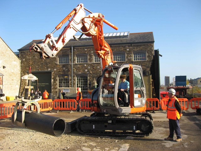 Mini-excavator at Railway Engineering Day: Pupil controlling the mini-excavator under supervision