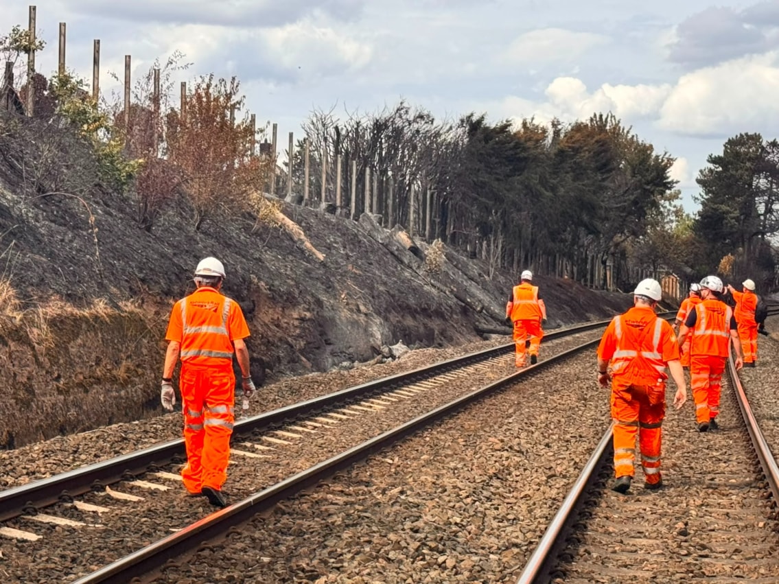 Network Rail teams inspecting fire damage to the railway embankment