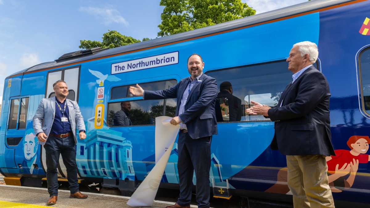 Alex Hornby, commercial and customer director, unveils train artwork celebrating the reopening of the Northumberland Line