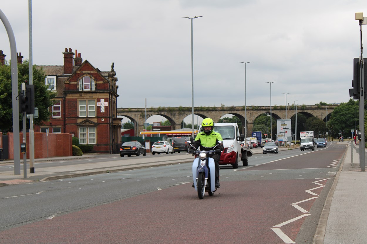 Motorcycle on A65 bus lane: Moped using the A65 Kirkstall Road bus lane as part of trial for motorcycles to use the bus lanes on the route.
