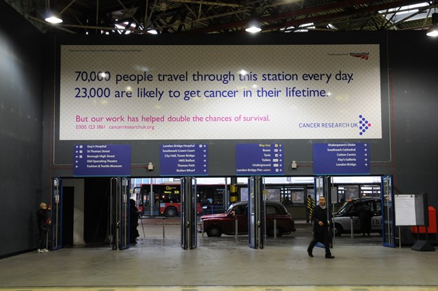LONDON BRIDGE BILLBOARD GIVES PASSENGERS SOMETHING TO THINK ABOUT: Cancer Research UK billboard at London Bridge
