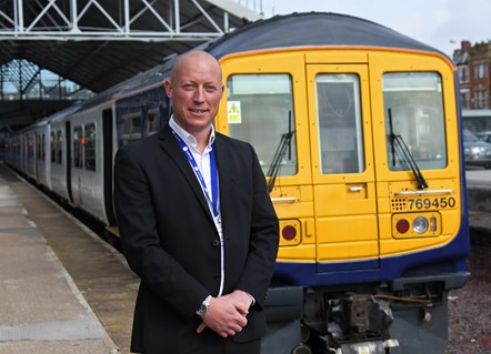 Chris Jackson with 769450: Regional Director Chris Jackson stand with one of Northern's bi-mode 769 trains