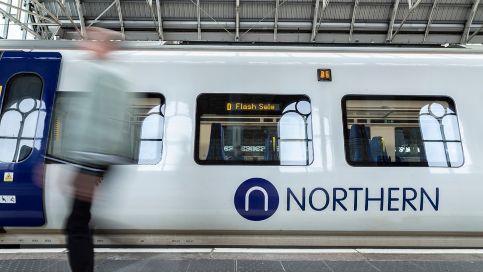 Image shows passenger alongside Flash Sale branded Northern train