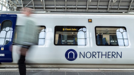 Image shows passenger alongside Flash Sale branded Northern train