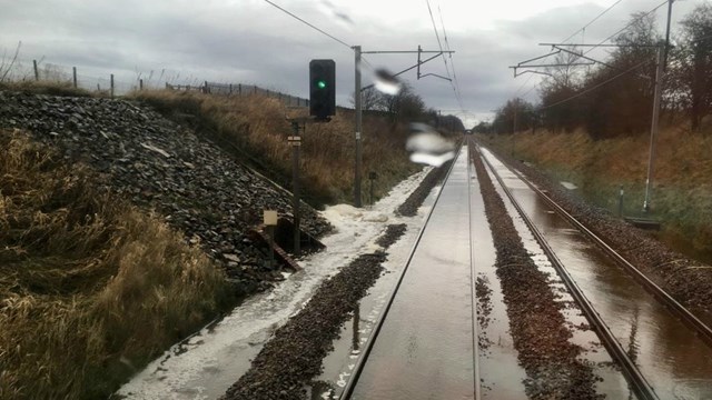 Passengers warned of West Coast main line disruption due to heavy rain today: Stock images of previous flooding from Storm Ciara February 2020