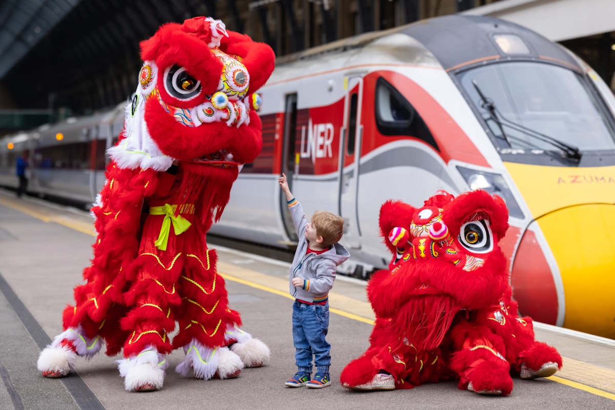 LNER Lions at King's Cross with young customer ahead of Chinese New Year
