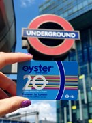 TfL Image - 20th Anniversary Oyster card in front of roundel: TfL Image - 20th Anniversary Oyster card in front of roundel